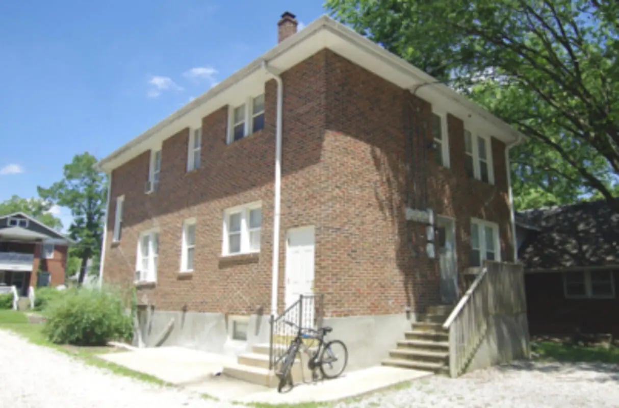 Brick building with stairs and bicycle exterior at Denice.com in Columbia Student Accommodation