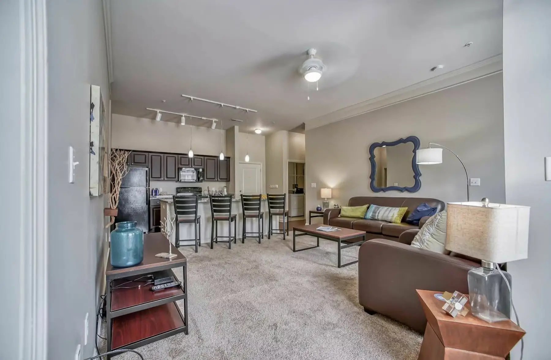 Sofa kitchen bar stools coffee table living room at University Edge Apartments in Akron Student Accommodation