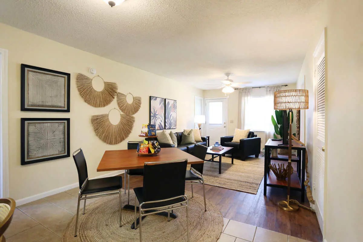 Dining area with chairs and living room. at Market 100 in Statesboro Student Accommodation