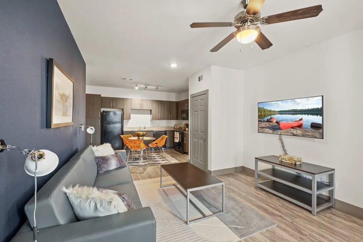 Sofa coffee table kitchen and dining area living room at Holleman Crossing in College Station Student Accommodation