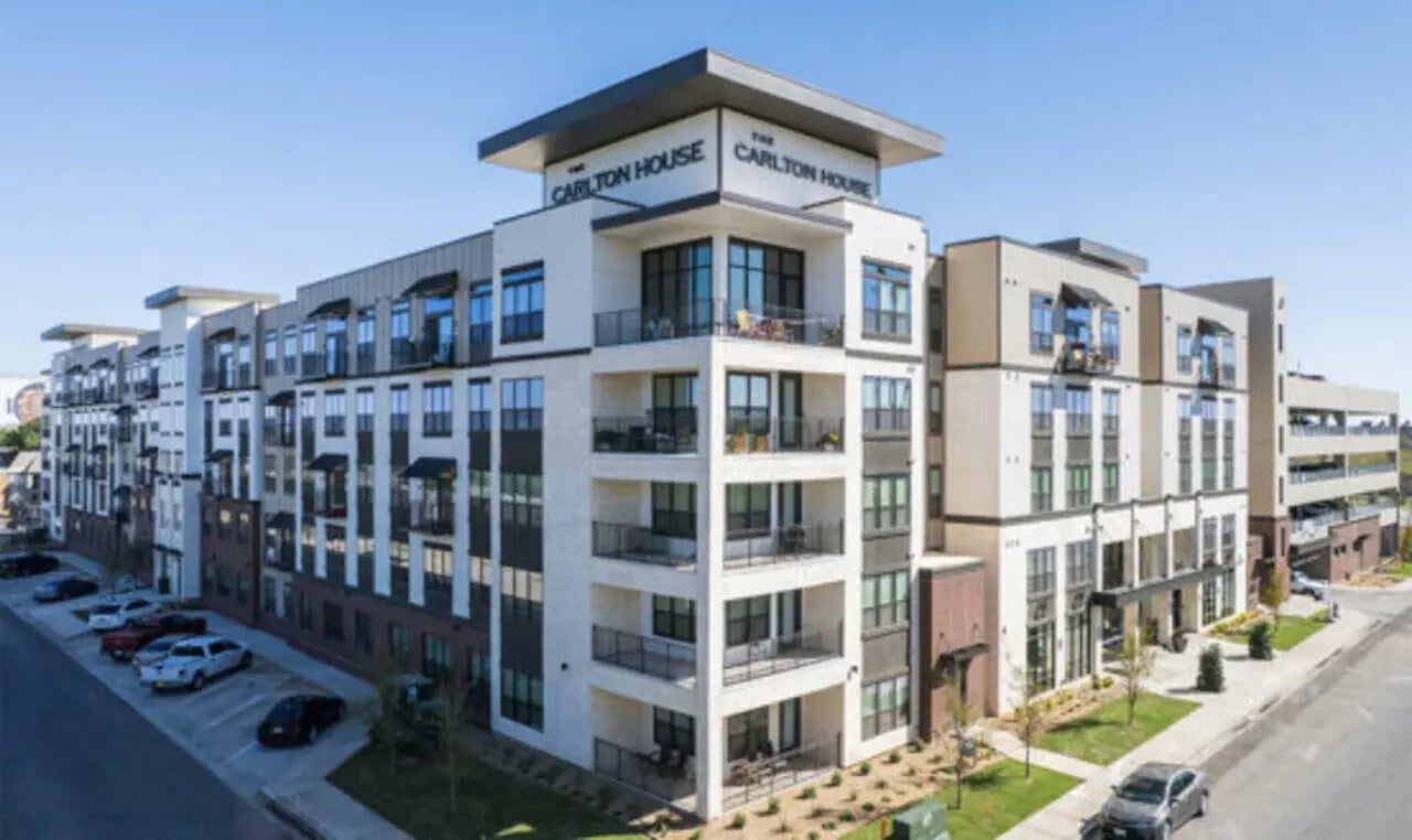 Modern apartment building with balconies and cars exterior at The Carlton House in Lubbock Student Accommodation