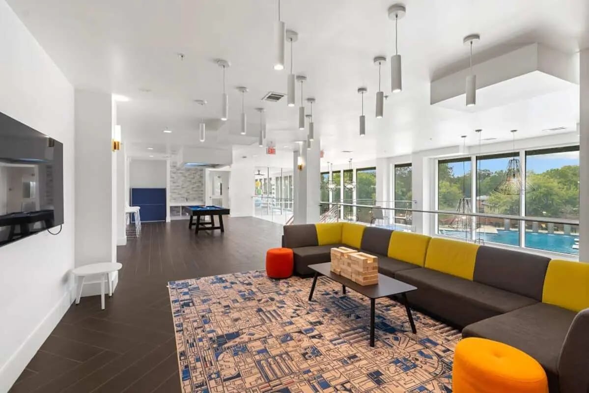 Sofa pool table rug and TV living room at The View on the Square in San Marcos Student Accommodation