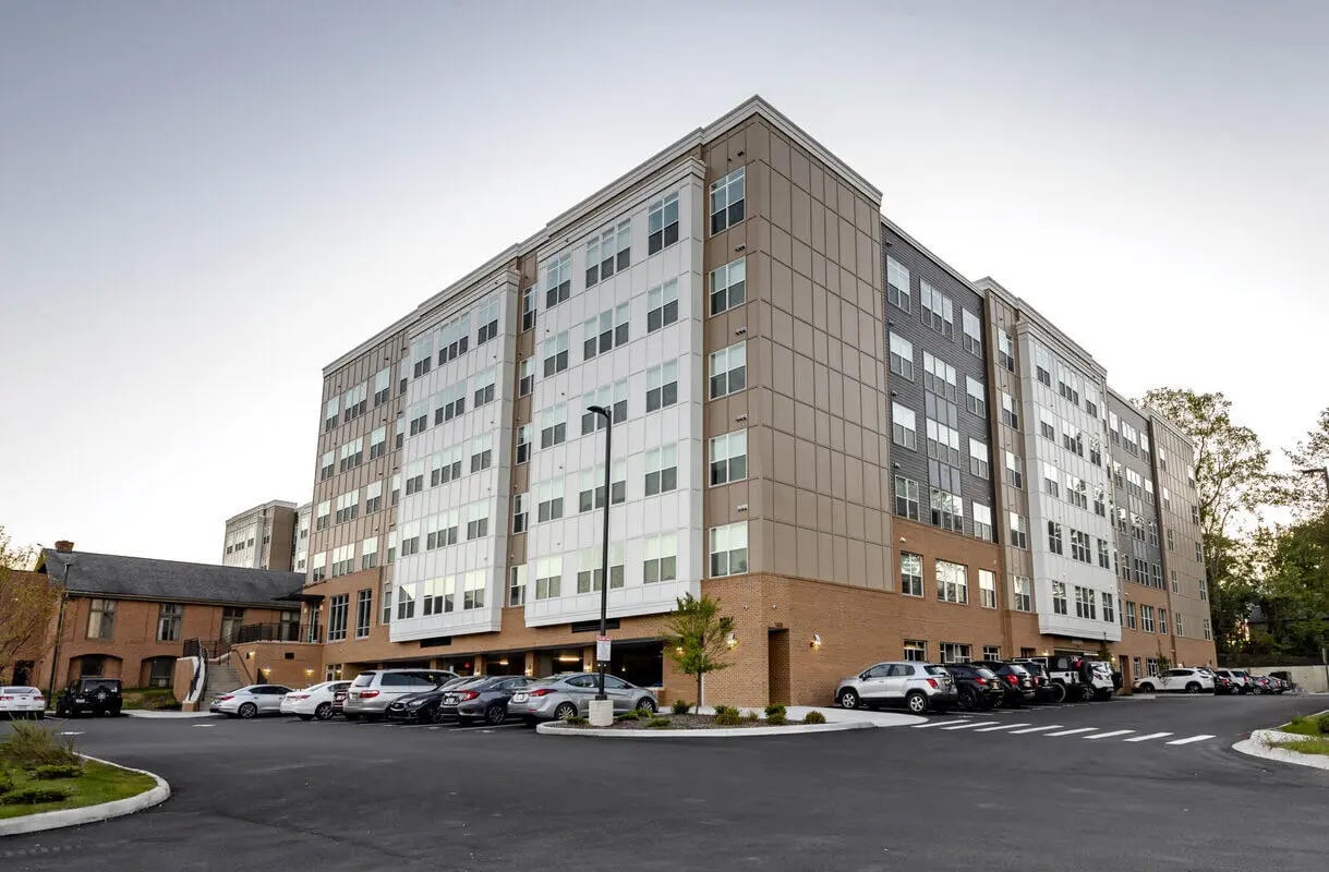 Modern apartment building with parking lot exterior at Paloma Kent in Kent Student Accommodation