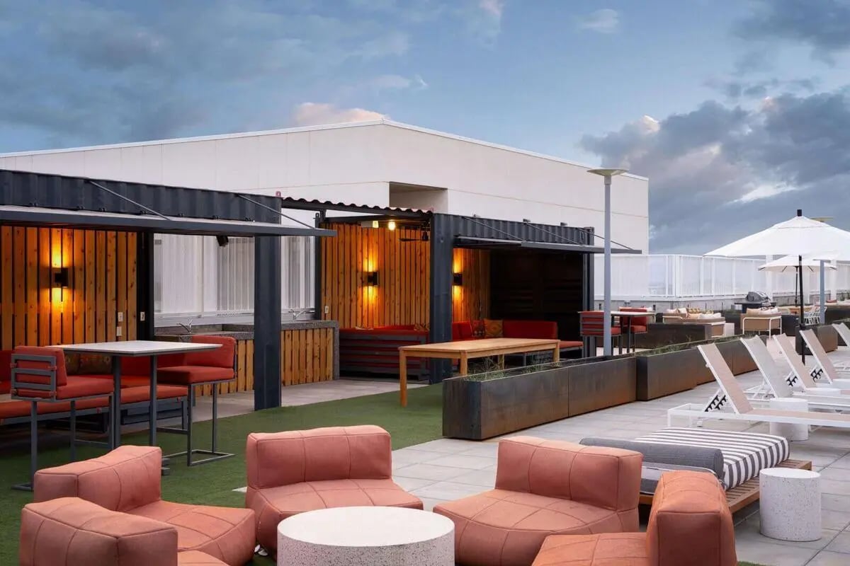 Outdoor seating dining areas lounge chairs exterior at The Carmin in Tempe Student Accommodation