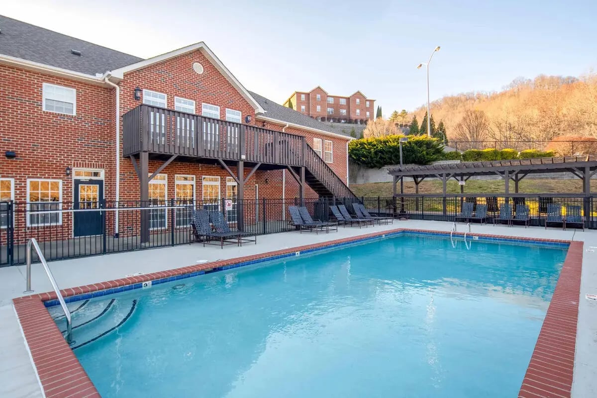 Swimming pool with lounge chairs exterior at Mountaineer Village in Boone Student Accommodation