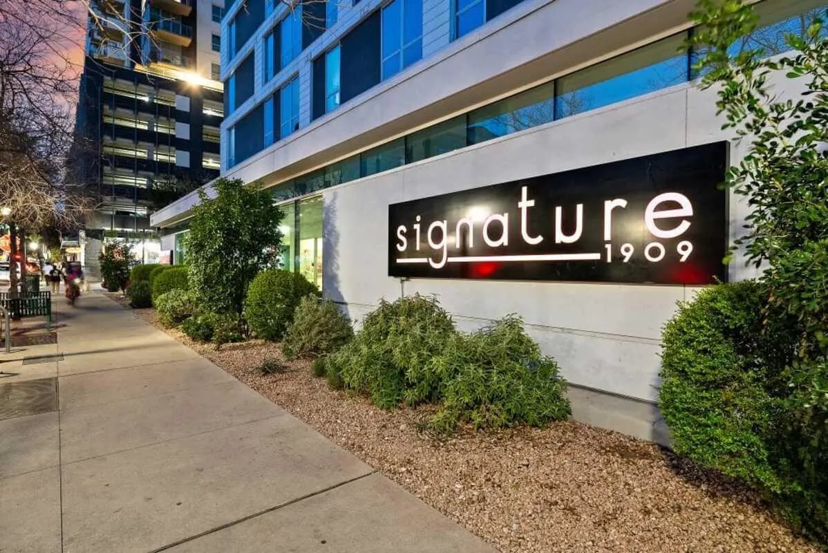 Building with sign and landscaping exterior at Signature 1909 in Austin Student Accommodation