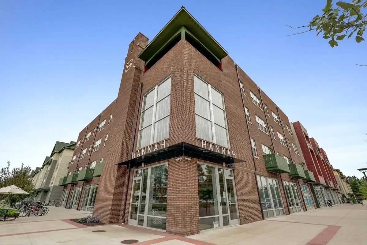 Brick student accommodation with balconies and large windows exterior at Hannah Townhomes & Lofts in East Lansing Student Accommodation