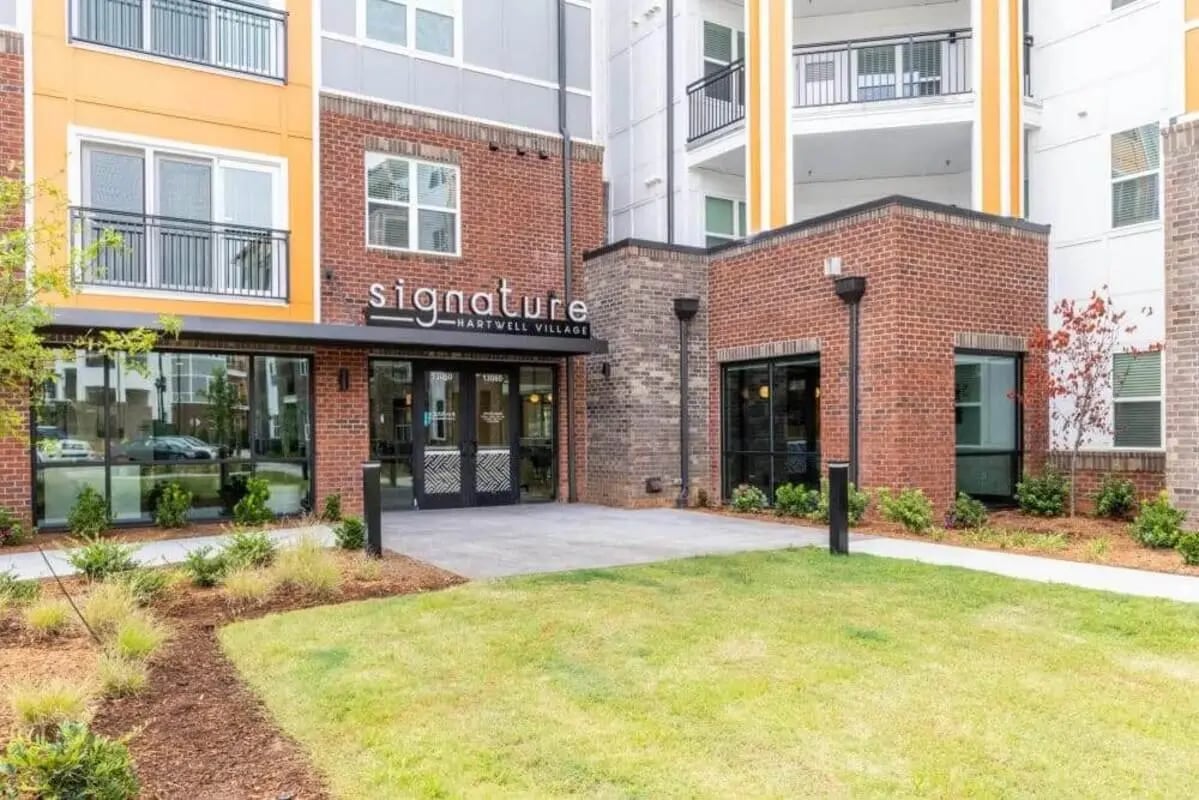 Entrance with modern architecture and green lawn exterior at Signature Hartwell Village in Seneca Student Accommodation