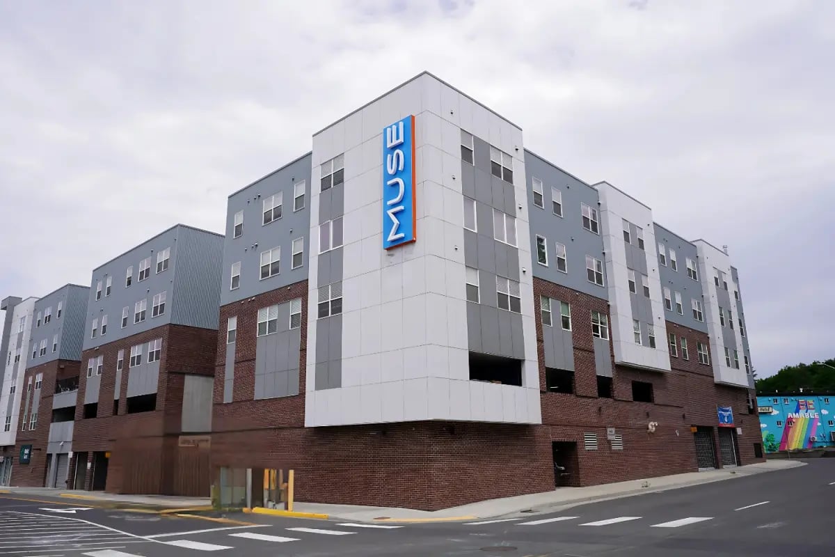 Modern apartment building exterior with Muse signage exterior at Muse on Main in Pullman Student Accommodation