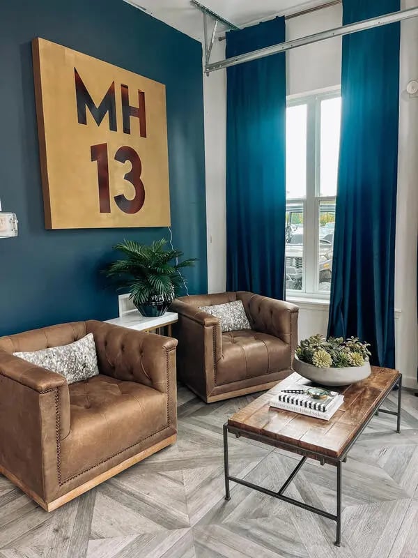 Two leather armchairs and coffee table living room at My House on 13th in Tuscaloosa Student Accommodation