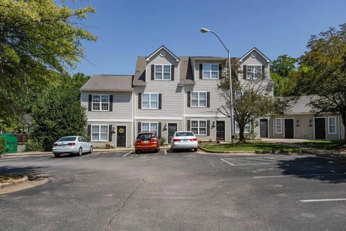 Townhouses with cars in parking lot exterior at Method Townhomes in Raleigh Student Accommodation