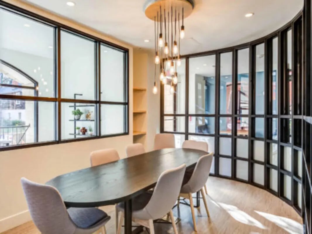 Dining table with chairs and modern chandelier study area at Wertland Square in Charlottesville Student Accommodation