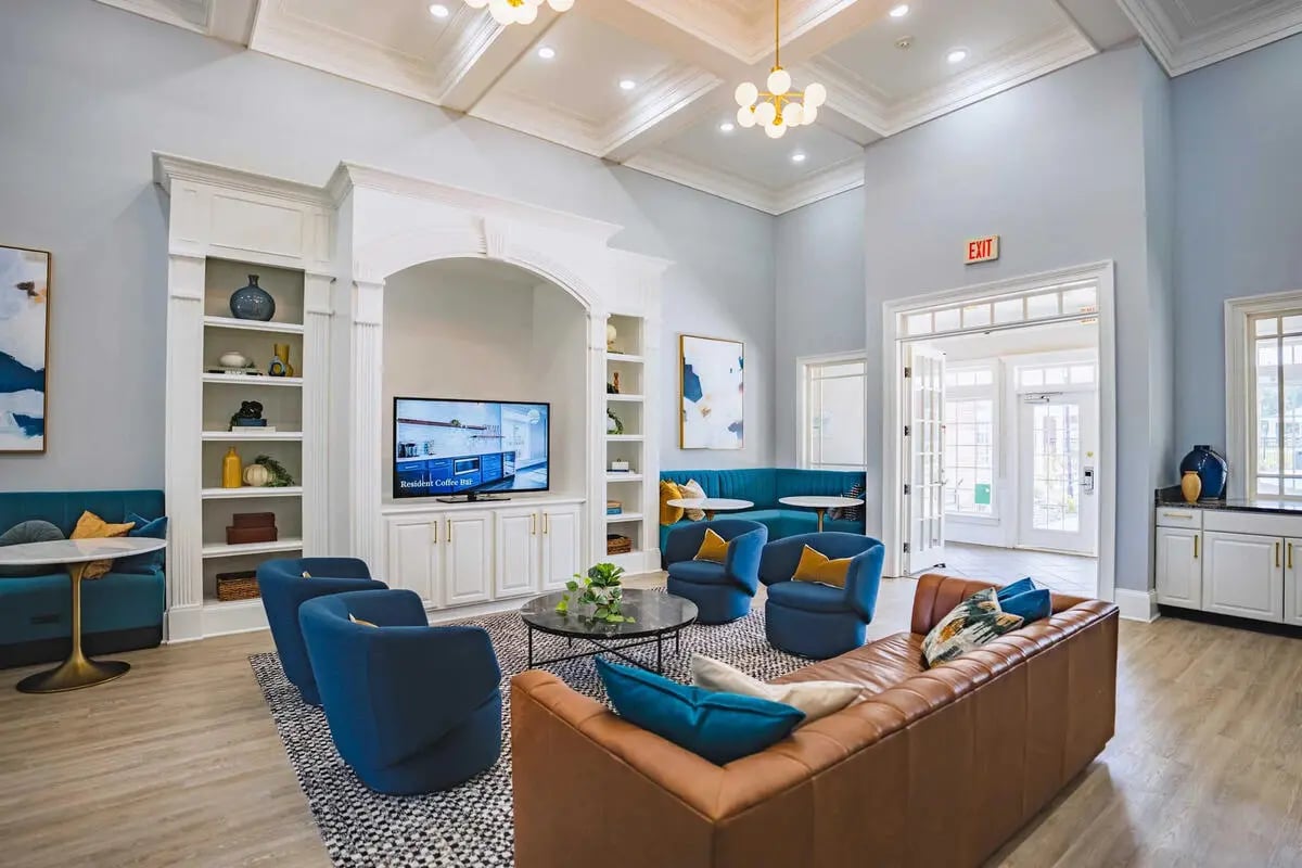 Large lounge area with seating and TV living room at The Lodge on the Trail Apartments in West Lafayette Student Accommodation