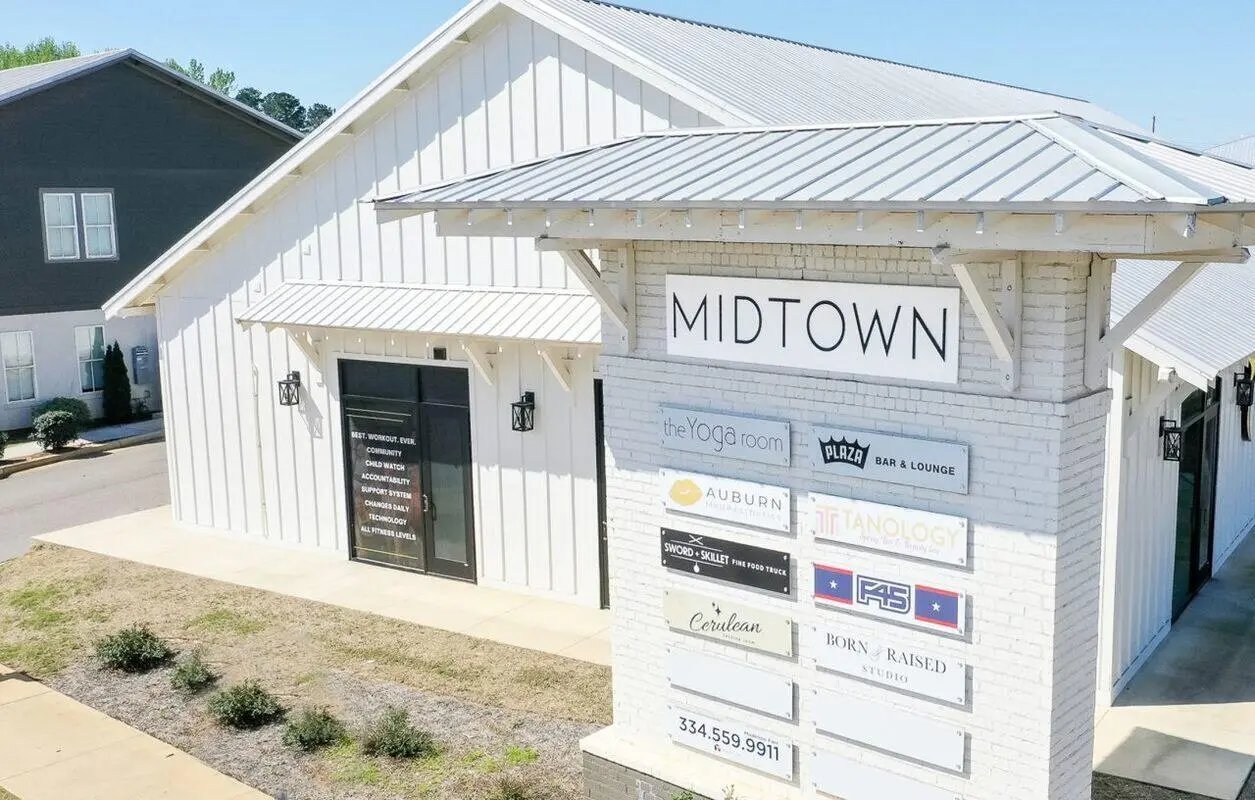 Midtown sign with multiple business signs Exterior at Midtown Auburn in Auburn Student Accommodation
