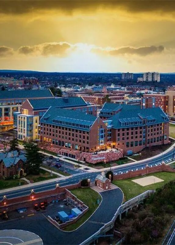 Campus buildings with brick facades and blue roofs exterior at SoCam 290 Apartments in New Brunswick Student Accommodation