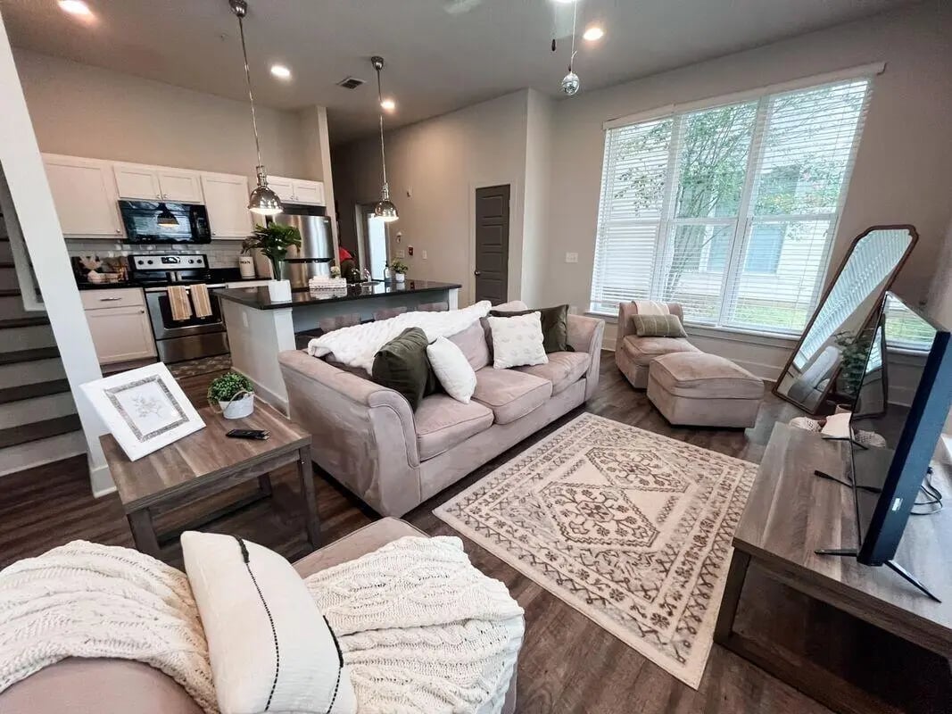 Sofa rug chaise lounge mirror living room at The Highlands in Reno Student Accommodation