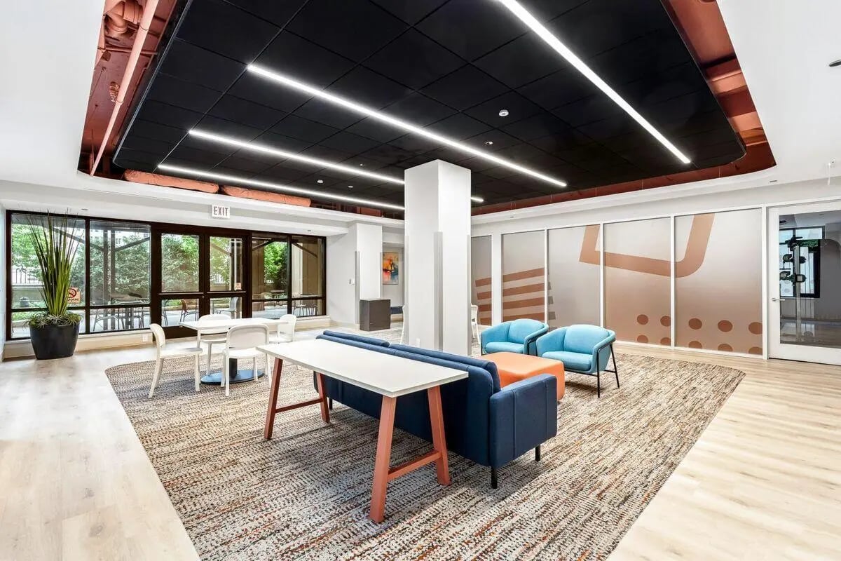Modern lounge with blue sofas and tables common area at University Center in Chicago Student Accommodation