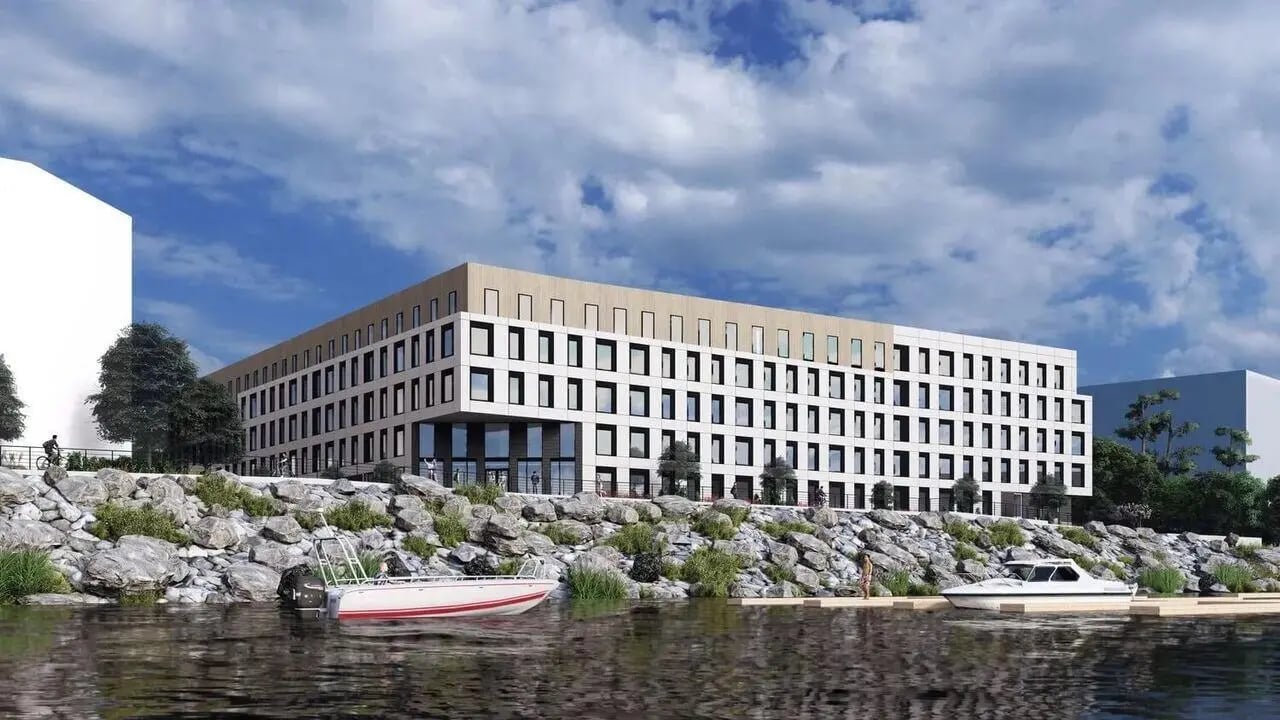 Modern building with boats on water exterior at Villas Knoxville in Knoxville Student Accommodation