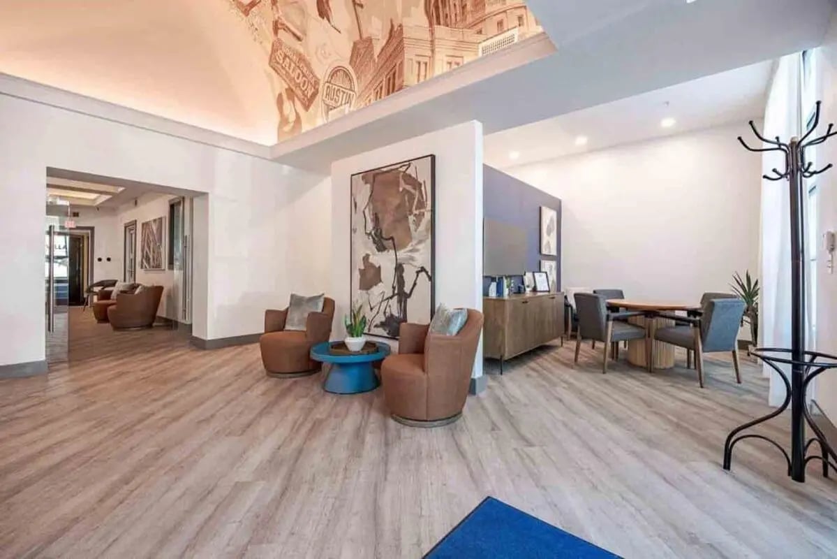 Lounge area with chairs tables and buffet living room at Villas On Guadalupe in Austin Student Accommodation