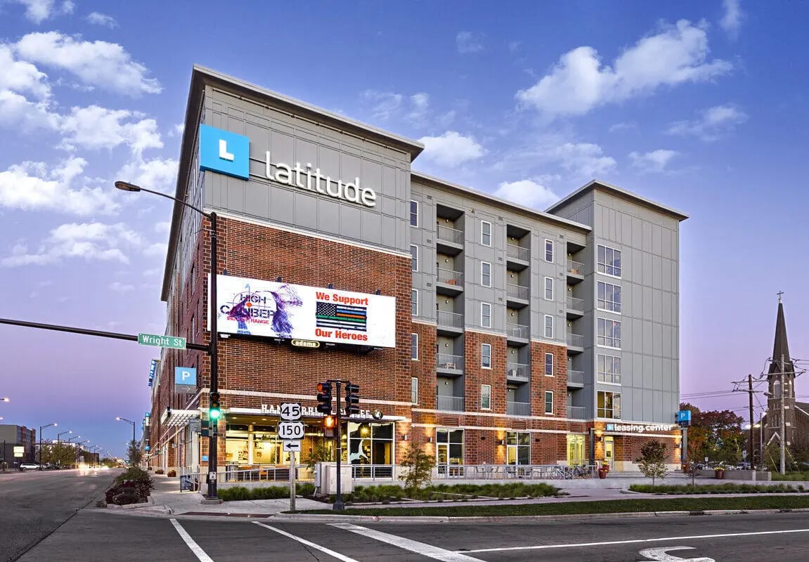 Modern apartment building with balconies and street view exterior at Latitude Apartments in Champaign Student Accommodation