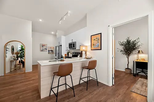 Modern kitchen island with bar stools and desk area kitchen at Nine 31 Apartments in Gainesville Student Accommodation