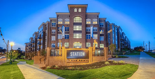 Modern brick apartment building exterior with signage exterior at Station at Five Points in Columbia Student Accommodation