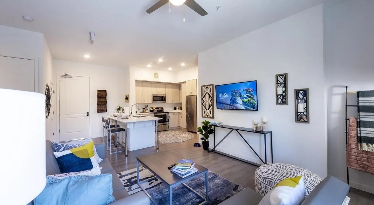 Modern living room with kitchen and television living room at Sterling 5th Street in Davis Student Accommodation