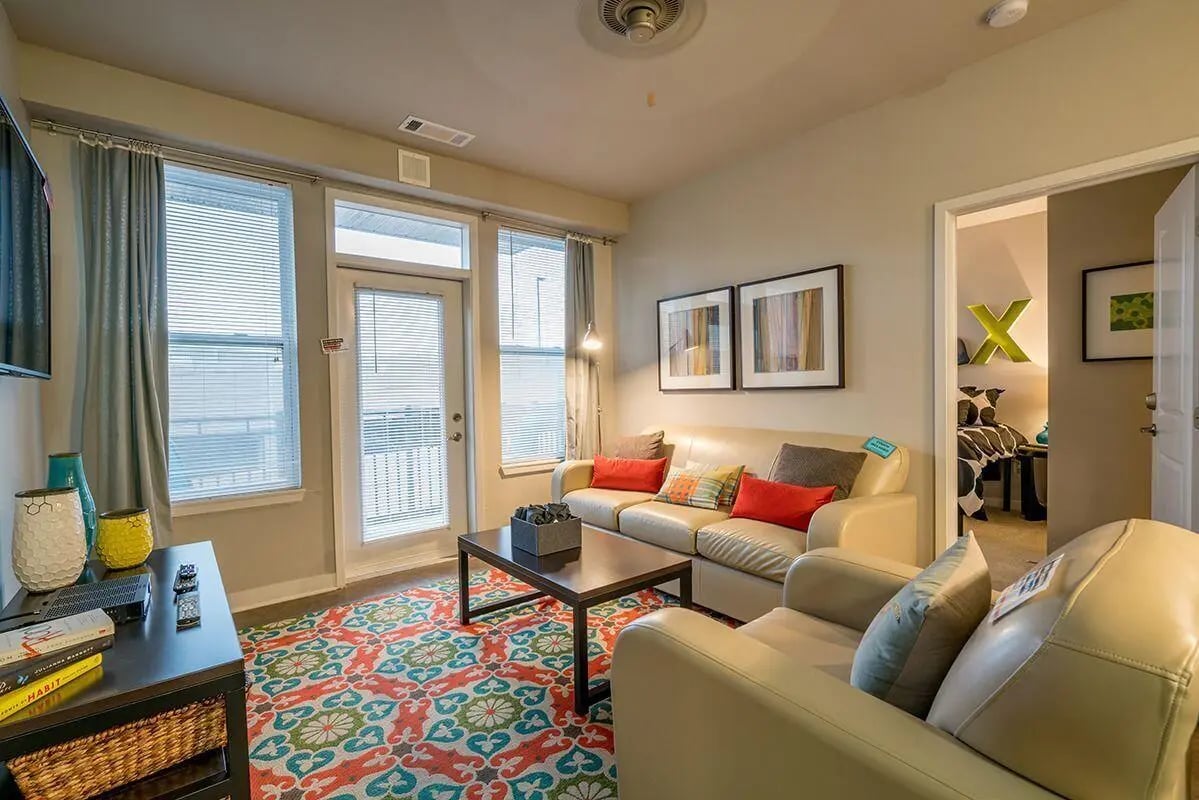 Cream sofas coffee table patterned rug living room at The Avenue Indianapolis in Indianapolis Student Accommodation