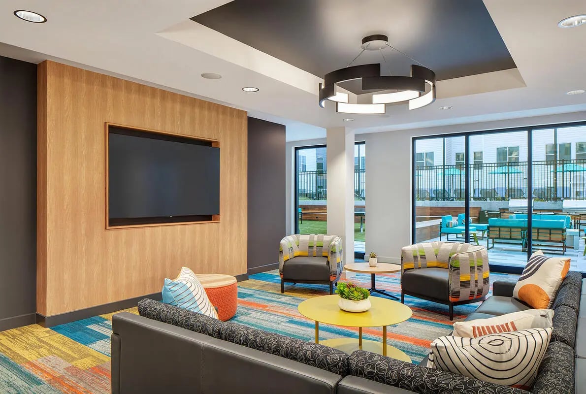 Modern lounge with sectional sofa and chairs Living room at Altus Towson Row in Towson Student Accommodation