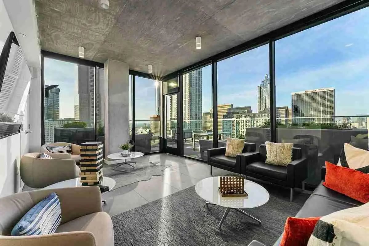 Couches chairs tables connect four game living room at Reflection Student Apartments in Atlanta Student Accommodation