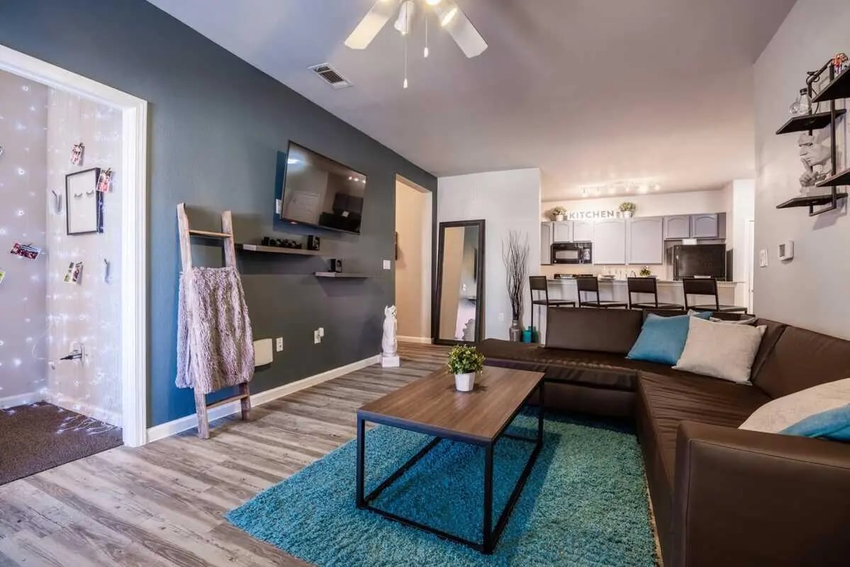 Brown sectional couch coffee table living room kitchen living room at Hill Country Place in San Antonio Student Accommodation
