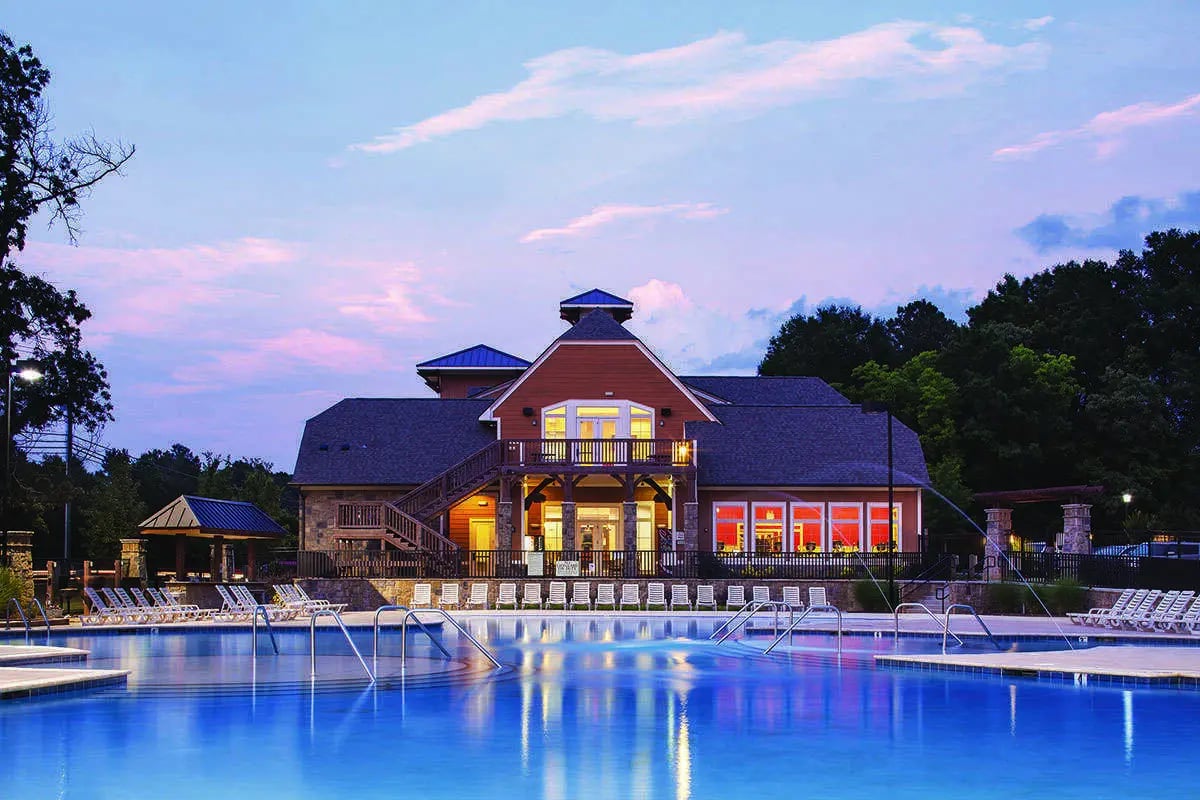 Pool lounge chairs and building exterior exterior at Redpoint in Raleigh Student Accommodation
