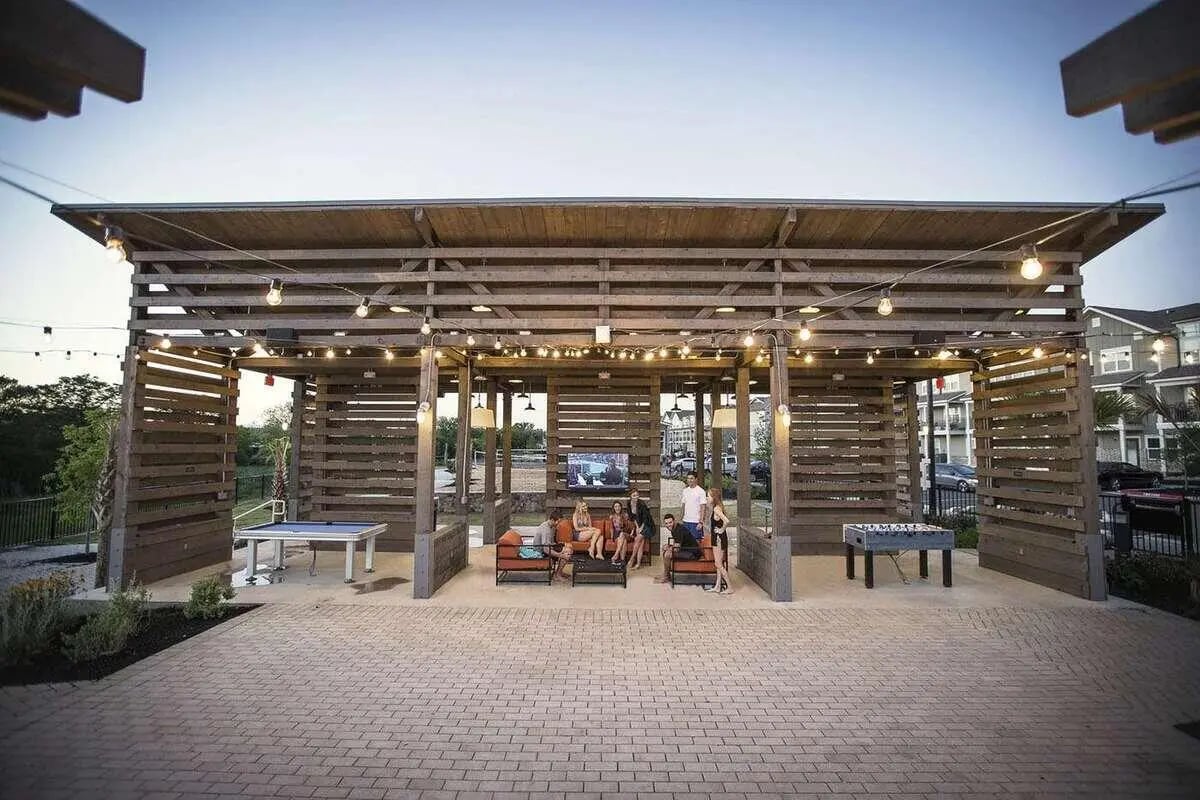Wooden pavilion with seating tv foosball table exterior at Redpoint San Marcos in San Marcos Student Accommodation