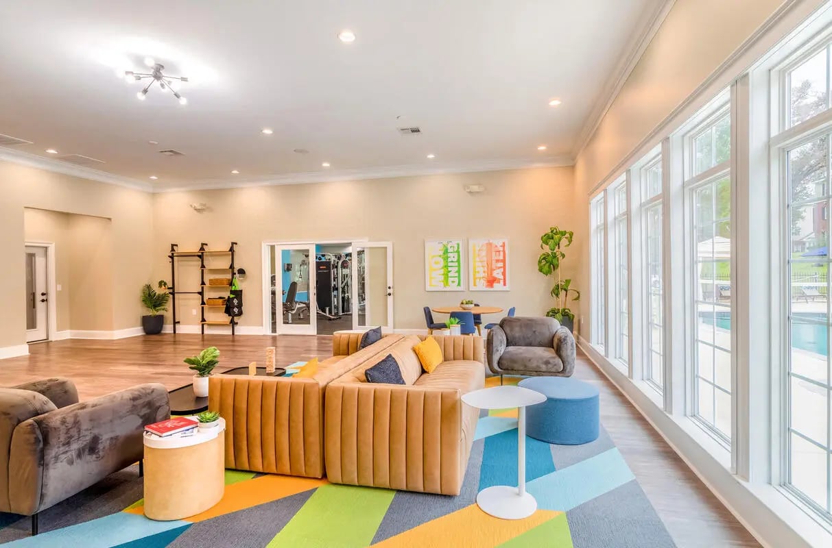 Living room with large sectional sofa and armchair living room at The Grove at Huntsville in Huntsville Student Accommodation