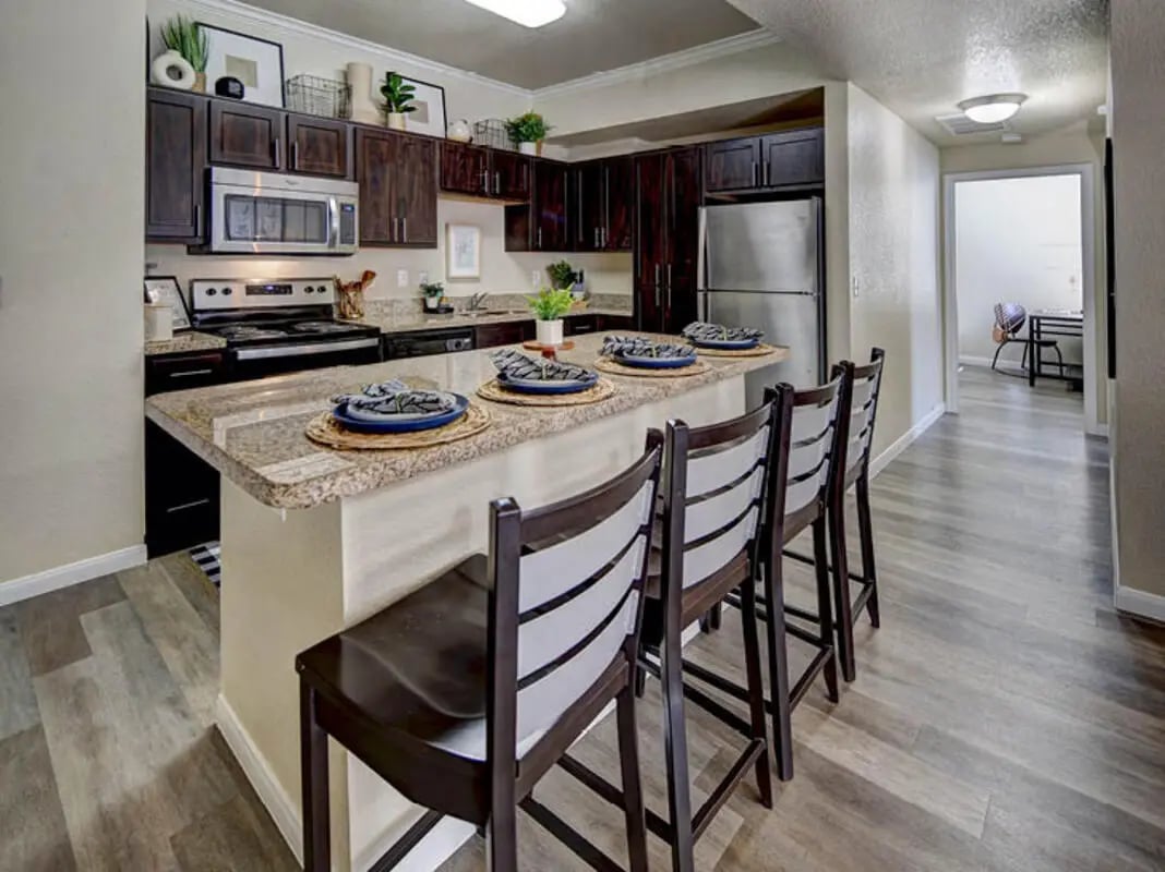 Kitchen island with bar stools and appliances kitchen at Campus Edge on UTA Boulevard in Arlington Student Accommodation