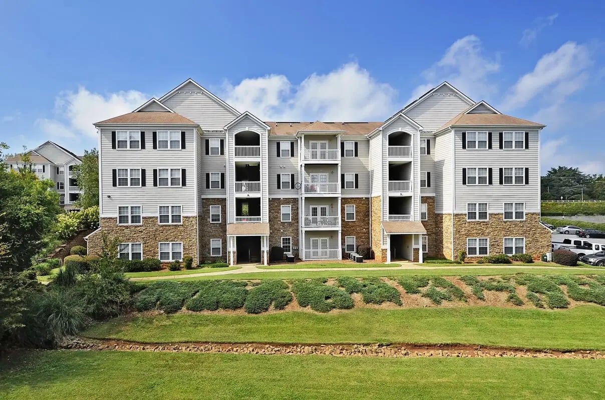 Apartment building with balconies and stone facade exterior at The Reserve at Clemson in Central Student Accommodation