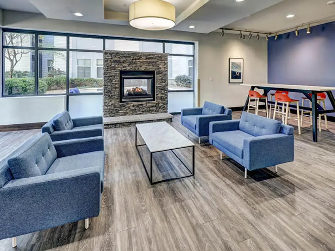 Blue sofas stone fireplace coffee table living room at 8 1/2 Canal Street in Richmond Student Accommodation