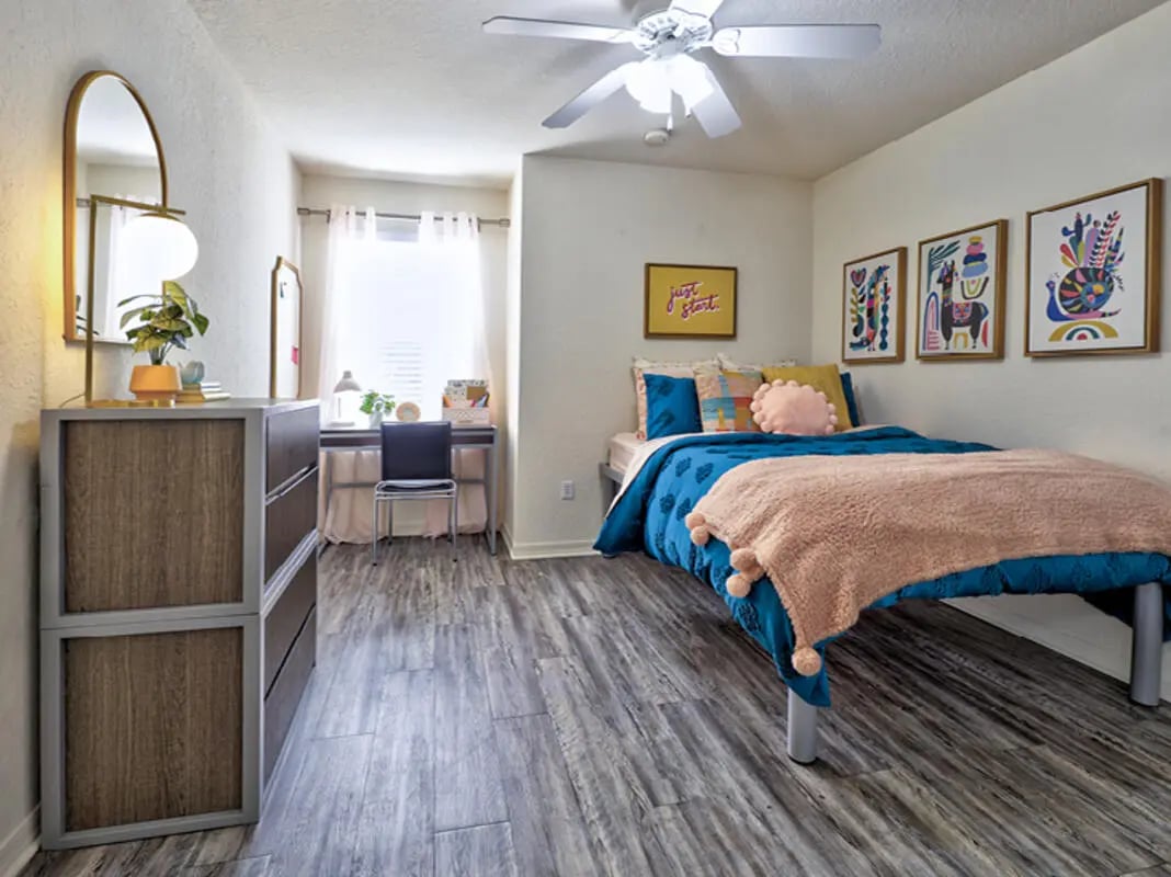 Bed dresser desk and artwork bedroom at Mercury 3100 in Orlando Student Accommodation