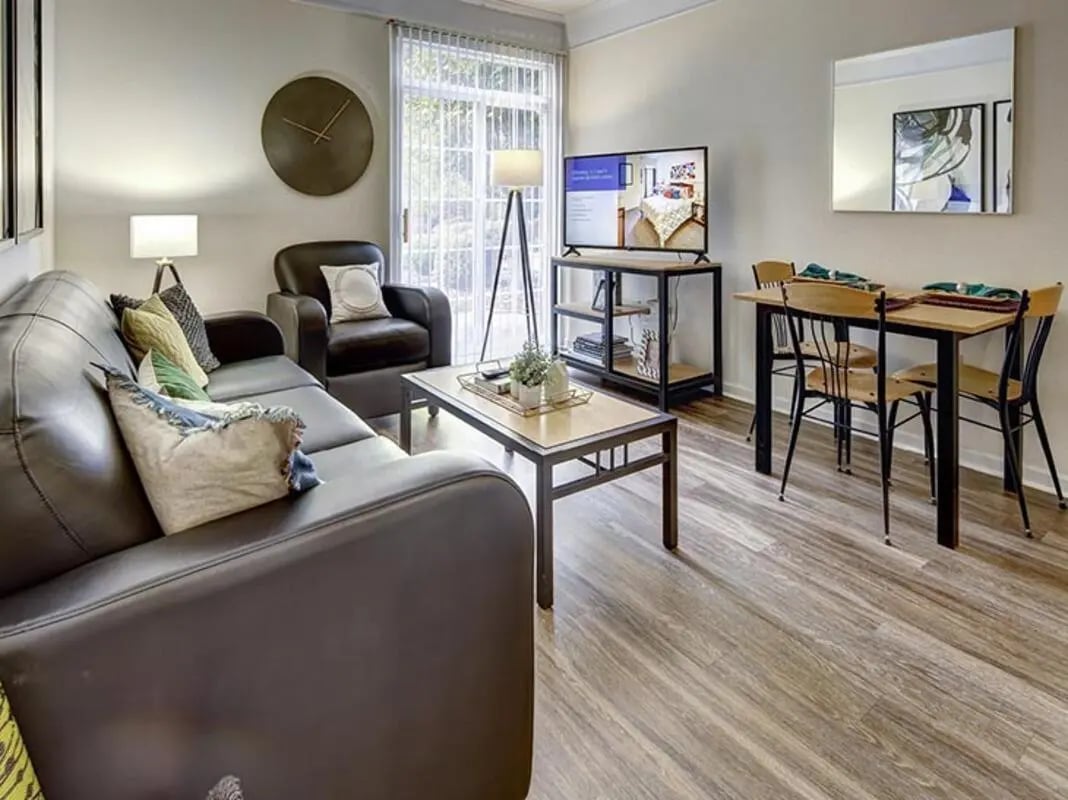 Leather sofa coffee table dining table living room at Newtown Crossing in Lexington Student Accommodation