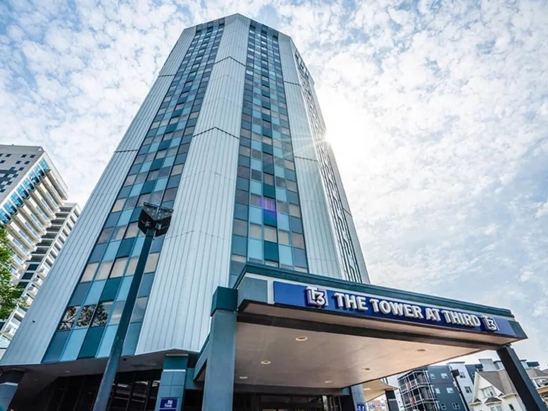 Tall building with windows and entrance exterior at The Tower at Third in Champaign Student Accommodation