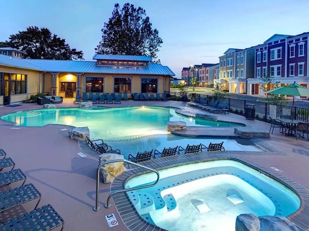 Pool and jacuzzi with loungers exterior at The Townhomes at Newtown Crossing in Lexington Student Accommodation