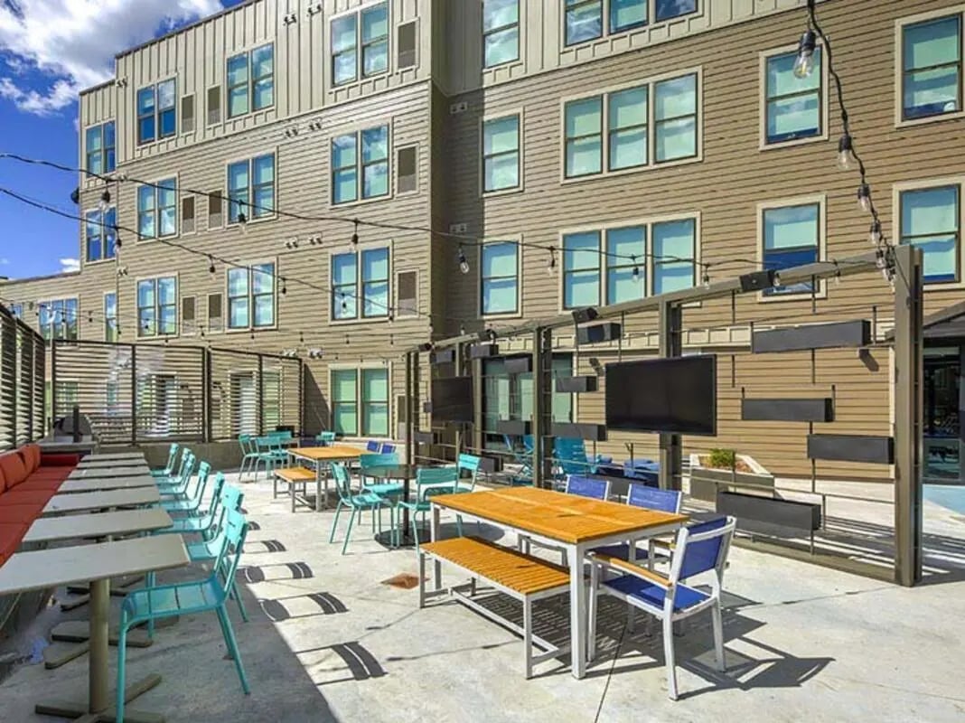 Outdoor seating area with tables and chairs exterior at The Jack in Flagstaff Student Accommodation