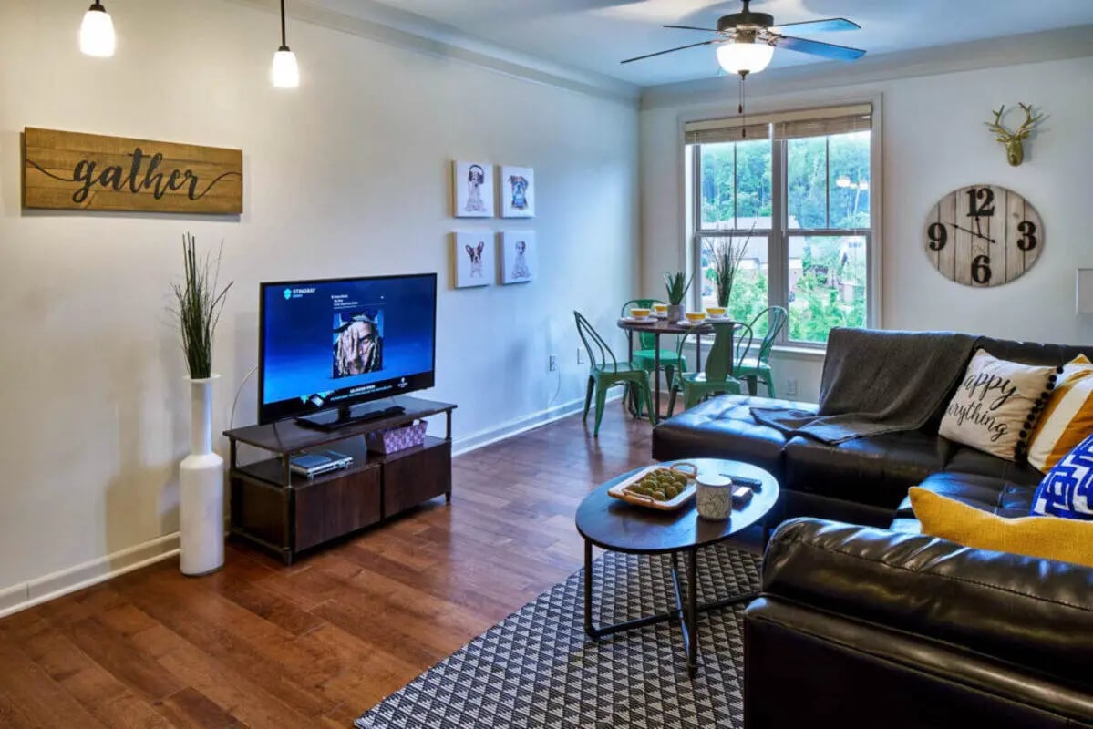 Living room with TV couch and dining area living room at Arcadia Student Living in Charlotte Student Accommodation