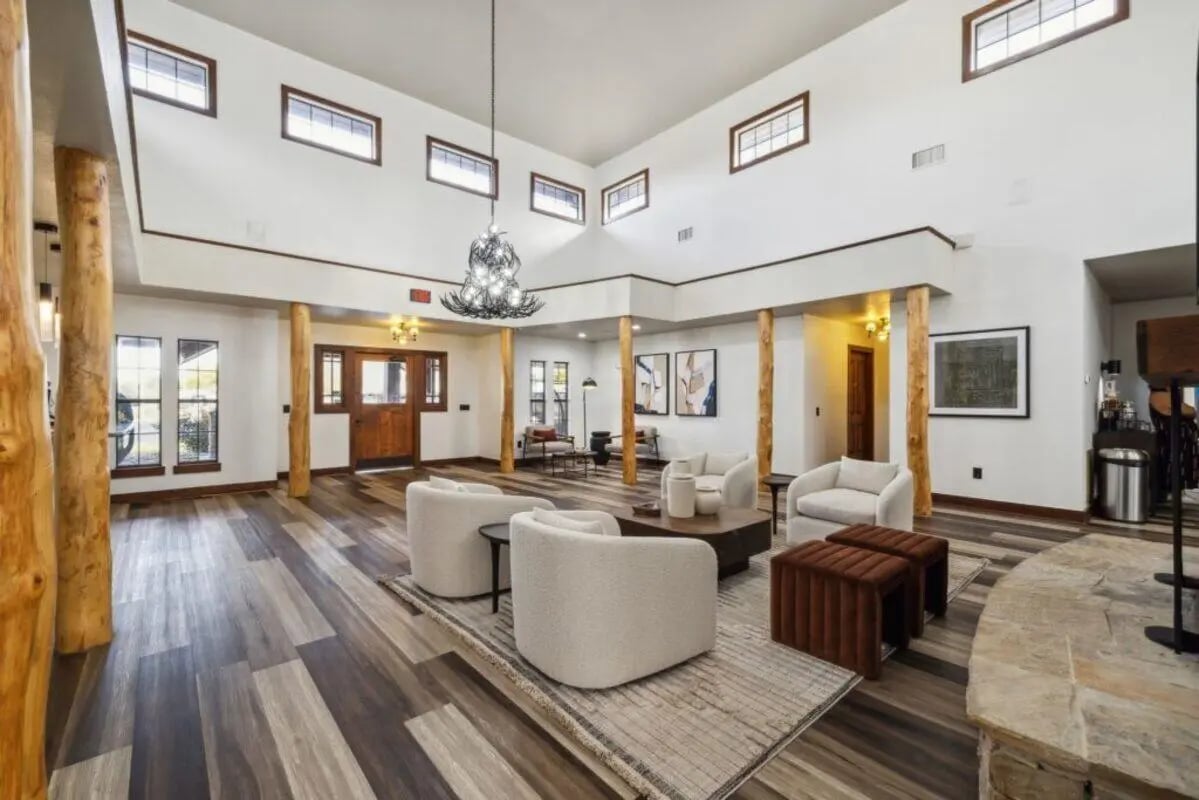 Chairs coffee table art wooden pillars living room at Montara Park in Norman Student Accommodation