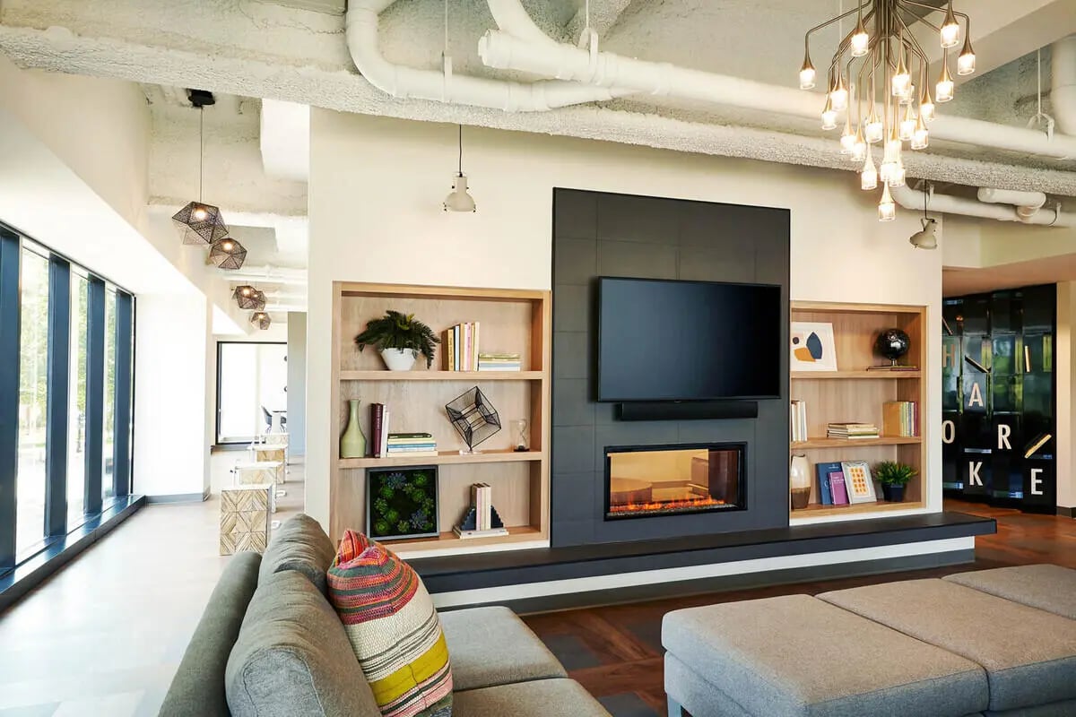 Modern lounge with fireplace TV and seating living room at Seven07 in Champaign Student Accommodation