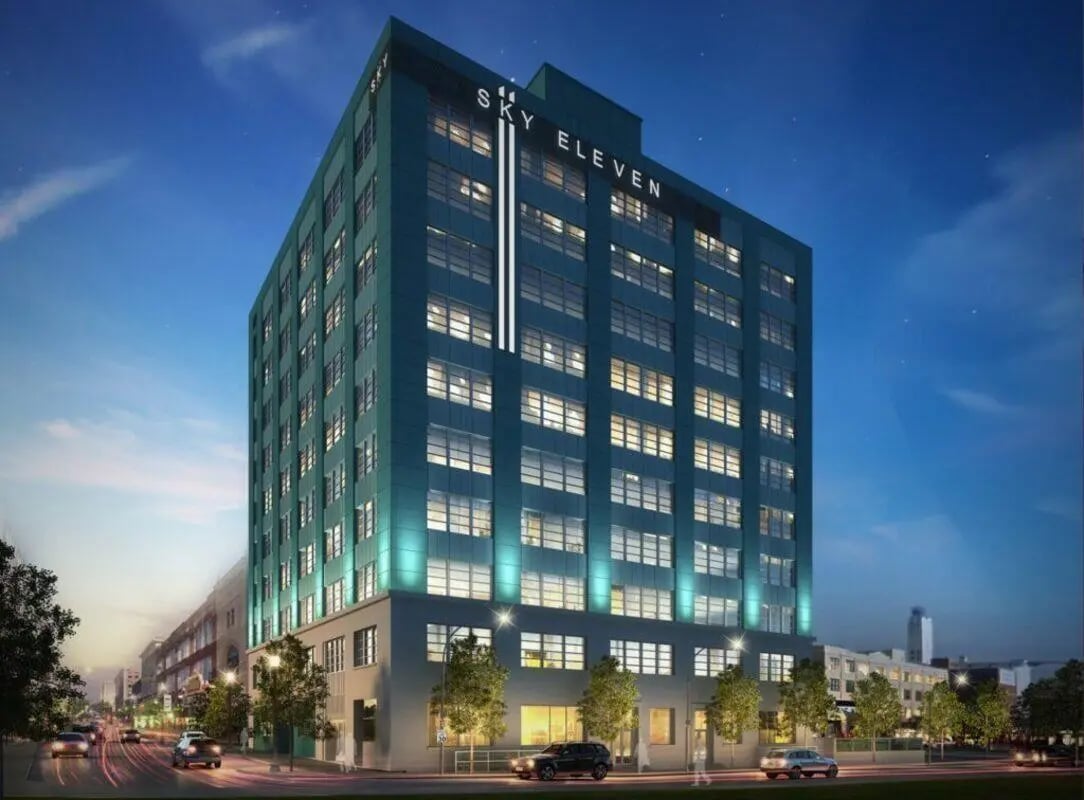 Modern teal building with many windows exterior at Sky Eleven in Springfield Student Accommodation