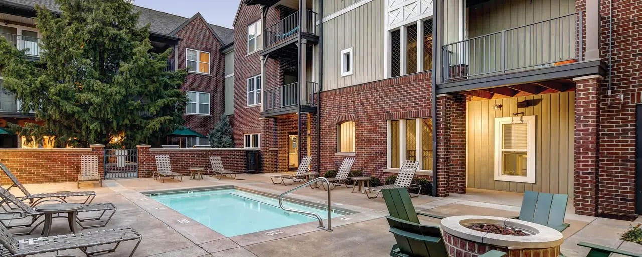 Pool lounge chairs and fire pit area exterior at The Lodges of East Lansing in East Lansing Student Accommodation