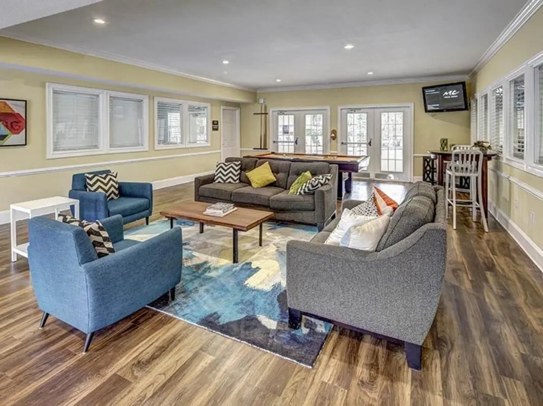 Sofas chairs pool table television living room at University Club Apartments in Gainesville Student Accommodation