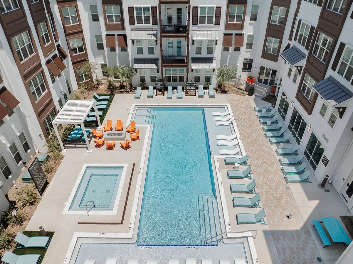 Pool spa lounge chairs and building exterior at Current Orlando in Orlando Student Accommodation