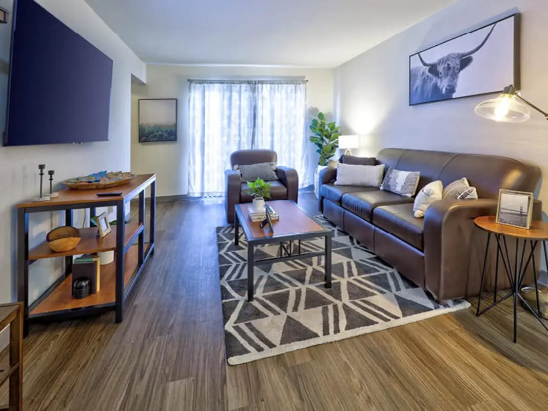 Brown leather sofa and chair living room living room at Willowtree Apartments & Tower in Ann Arbor Student Accommodation